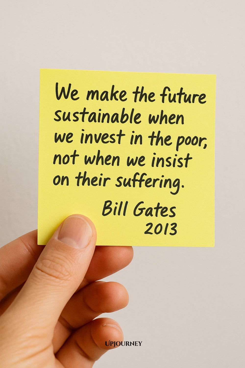A hand holding a yellow sticky note with handwritten text: "We make the future sustainable when we invest in the poor, not when we insist on their suffering. Bill Gates 2013"